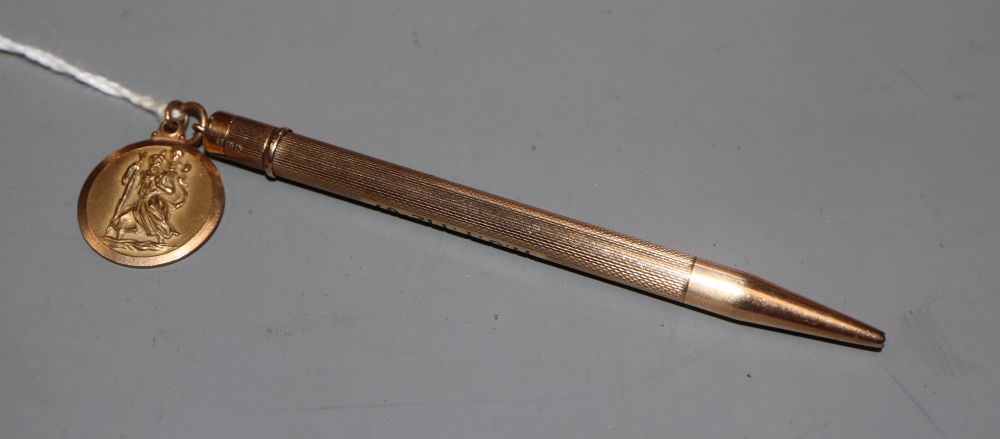 A 9ct gold cased propelling pencil, 87mm and a 9ct gold pendant( 3.2 grams).